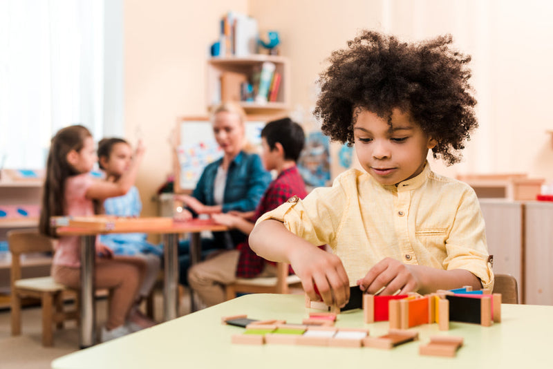 Preschool child counting and sorting colorful objects during hands-on math play.